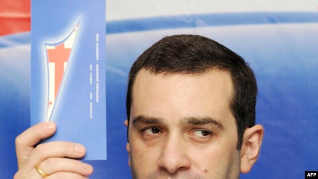 Irakli Alasania holds up a leaflet for his new party.