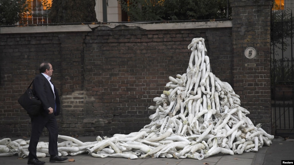 Piles on mannequin limbs are seen outside the Russian Embassy, as part of a protest against military action in Syria, in London on November 3.