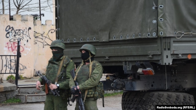 Armed men who are believed to be Russian troops on the streets of Simferopol.