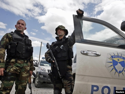 Members of the Kosovar special police forces stand by their vehicle in the ethnically divided town of Mitrovica on July 26.