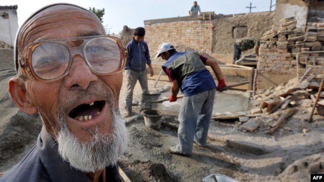 An ethnic Uzbek spoke as members of his family reconstructed their destroyed house in the village of Shark, outside Osh, soon after the ethnic violence in 2010.