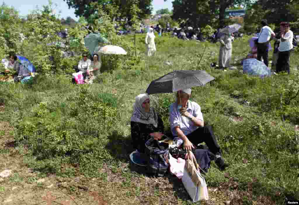 People wait for the ceremonial opening of the mosque on May 4.