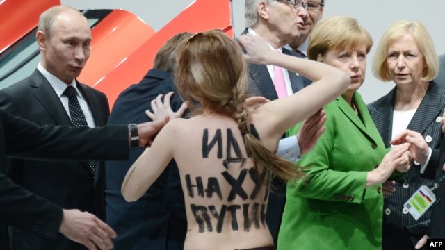 Femen activist Oleksandra Shevchenko described the reaction of Russian President Vladimir Putin (left) as "idiotic astonishment mixed with a smile and a stupid expression on his face." On her back is written "F*** you, Putin."