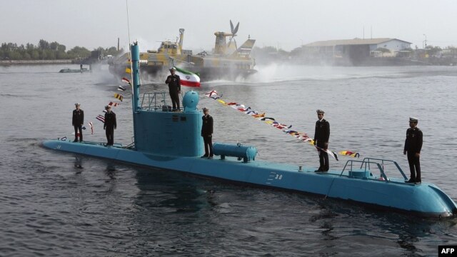 An Iranian Qadir light submarine and a hovercraft  move in Persian Gulf waters in late November.