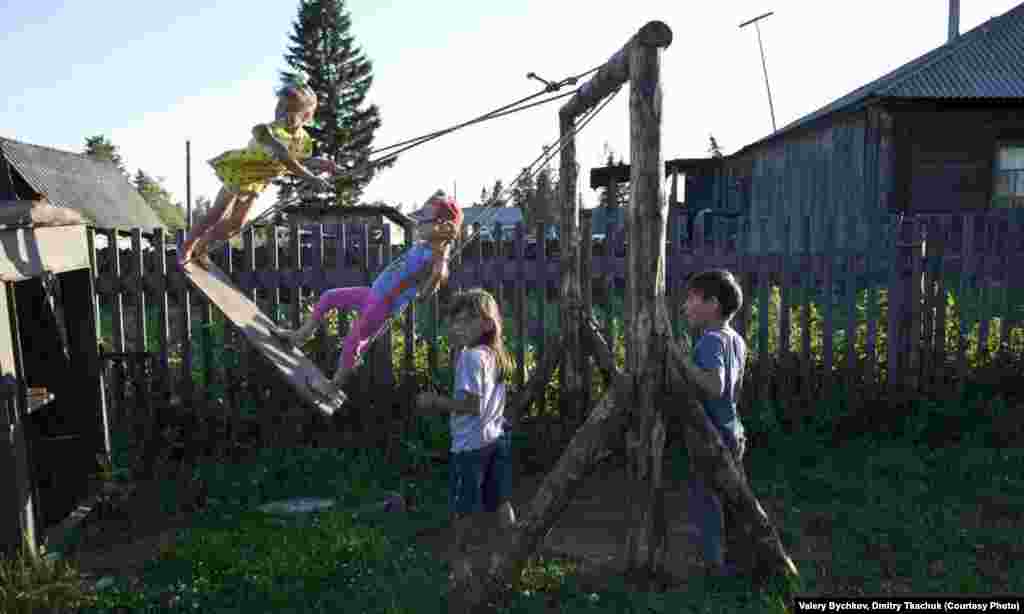 Children enjoy their backyard playground.