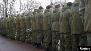 Ukrainian veterans of the Soviet war in Afghanistan stand with their backs turned to President Viktor Yanukovych as he attends a flower-laying ceremony in Kyiv.