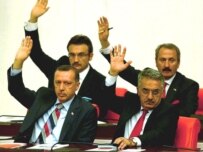 Turkish Prime Minister Erdogan (front left) votes with other deputies in parliament today (epa)