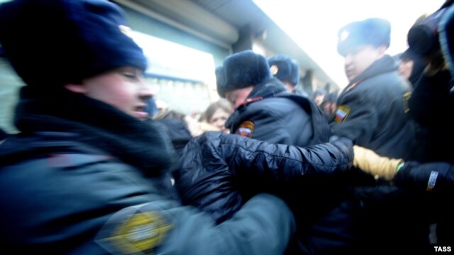 Russian police try to separate gay-rights activists and supporters of a new law against disseminating "homosexual propaganda" to minors outside the State Duma in Moscow. The bill is one considered by Human Rights Watch to be of "an absolutely regressive and repressive nature" passed recently.