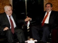 Al-Muallim (left) being greeted by Iraqi Foreign Minister Hoshyar Zebari in Baghdad on November 19 (epa)