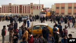 Diplaced Iraqis seeking refuge gather in a residential area on the outskirts of the city of Ramadi after fleeing ongoing battles between the Iraqi Army and antigovernment fighters in Anbar Province.
