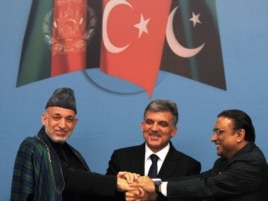 Turkey's Abdullah Gul (center) is all smiles with his Afghan and Pakistani counterparts, Hamid Karzai and Asif Ali Zardari.