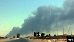 Smoke rises from the Baiji oil refinery in northern Iraq, in June 2014.