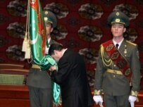 Berdymukhammedov kissing the flag during his inauguration (AFP)