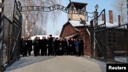 Members of an Israeli parliamentary delegation pose at the entrance to the former Auschwitz concentration camp during a ceremony to mark International Holocaust Remembrance Day on January 27.