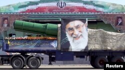 A military truck carrying a warhead and a picture of Iran's Supreme Leader Ayatollah Ali Khamenei is seen during a parade in Tehran late last year. Washington says the new sanctions have been imposed as a result of Iran's ballistic missile program.