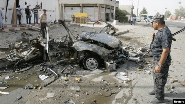 Iraqi security personnel inspect the site of a car-bomb attack in Kirkuk on August 16.