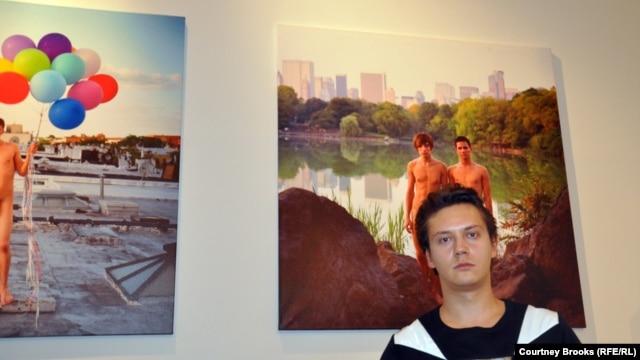 Russian-born photographer Alexander Kargaltsev stands in front of one of his portraits, of a gay couple posing in Central Park, at his exhibition launch on October 26.
