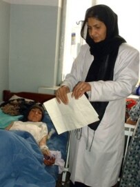 An Afghan doctor in Herat attends a female immolation victim in 2004 (AFP)