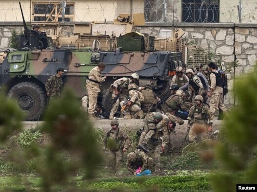 NATO and Afghan troops attend to casualties during the battle with Taliban insurgents who took over a building near the US Embassy in Kabul on September 13-14.