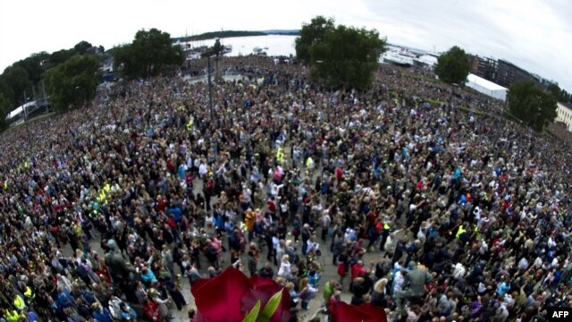 Roses lie on a balcony overlooking a vigil in Oslo attended by some 150,000 people holding flowers in a show of solidarity with the victims of recent attacks in Norway on July 25.