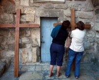 Christians in Jerusalem pray outside the Holy Sepulchre, traditionally believed to be the burial place of Jesus (epa)