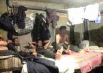 Tajik workers in cramped living quarters in Russia (RFE/RL)