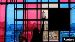 Ukraine - An employee decorates a window in a cafe before opening in Kharkiv, Ukraine, September 25, 2016