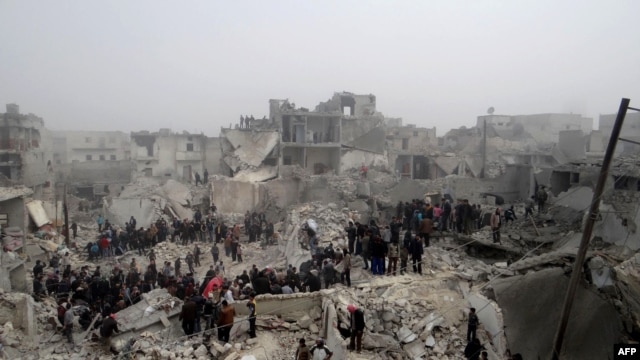People inspect the destruction following an apparent surface-to-surface missile strike on the northern city of Aleppo on February 19.