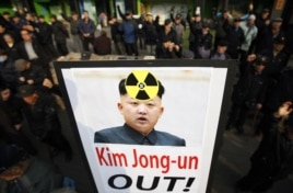 South Korea - Anti North Korea civic group hold signs and chant slogans during a rally denouncing North Korea's possible nuclear test plan, in Seoul, 31Jan2013