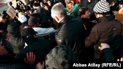 Four protesters were reportedly taken away by police with blood on their faces.