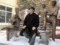 Sculptor Eduard Kazaryan poses next to his tribute to the Beatles in Almaty, Kazakhstan (TASS file photo)