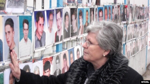 A photo of Nesrete Kumnova's son, Albion, is among the more than 300 such photos of the "not found" hanging on a fence outside the Kosovar parliament.