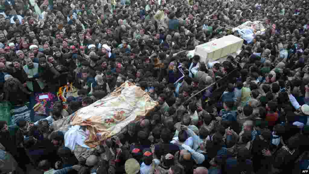 Shi'ite and Sunni Muslims gather as coffins of bomb blast victims arrive for funeral prayers in Rawalpindi, Pakistan. Muslim leaders gathered for a rare summit in Islamabad as militant attacks killed 36 people across the country on one of the deadliest days of violence claimed by the Taliban in months. (AFP/Farooq Naeem)