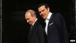 Greek Prime Minister Alexis Tsipras (right) talks with Russian President Vladimir Putin during their meeting in Athens, Greece, on May 27.