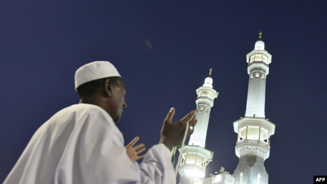 A Muslim pilgrim prays outside the Grand Mosque in Mecca, Saudi Arabia. Under King Abdullah, the kingdom has moved toward a more inclusive form of Islam.