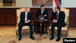 Egypt's President Abdel Fattah Al-Sisi (right) talks to Russian President Vladimir Putin (left) during their meeting at Cairo International Airport on February 9.