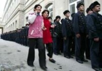 Azerbaijani girls walk along a long line of naval cadets waiting to vote (epa)