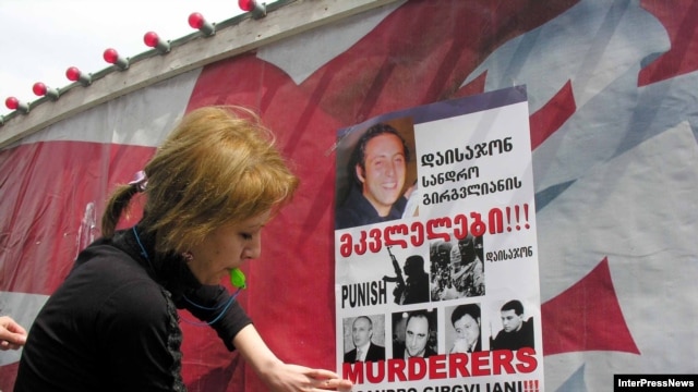 Demonstrators put up posters calling for the punishment of the "murderers of Sandro Girgvliani" at a rally in Tbilisi in April 2006.
