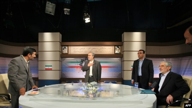 Incumbent Mahmud Ahmadinejad (left) and presidential challenger Mir Hossein Musavi (far right) in their televised debate on June 3.