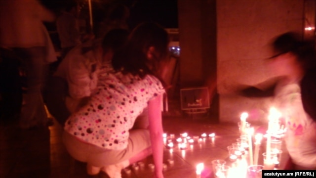 Armenia - Candles are put in a silent vigil otuside the Harsnakar restaurant in Yerevan, 30Jun2012.