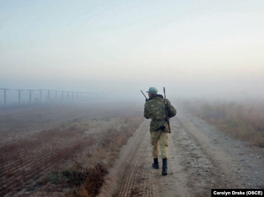 A Tajik border guard patrols the Afghan border, where illegal crossings, robberies, and kidnappings of Tajiks by Afghan drug smugglers are not unusual.