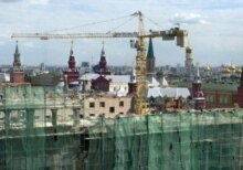 The Moskva being dismantled behind a shroud of green netting (ITAR-TASS) 