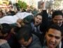 Egypt -- Protesters carry the body of a man killed during an attempt to storm the interior ministry in Cairo, 29Jan2011