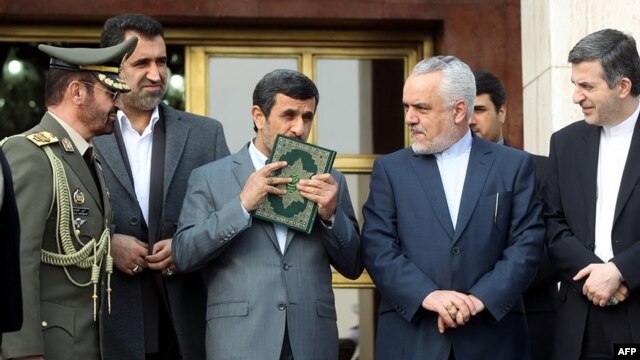 Президент Ахмадинежад целует Коран перед вылетом в Венесуэлу, 7 марта 2013 г.