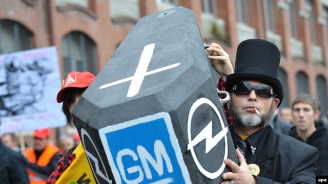 German Opel employees demonstrate outside the company's headquarters in Ruesselsheim.
