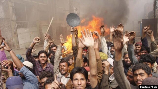 Members of the Christian community in Lahore protest on March 10 after a mob set fire to their homes.