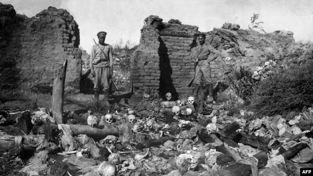A picture released by the Armenian Genocide Museum-Institute, dated 1915, which purportedly shows soldiers standing over skulls of victims from the Armenian village of Sheyxalan in eastern Turkey during World War I.