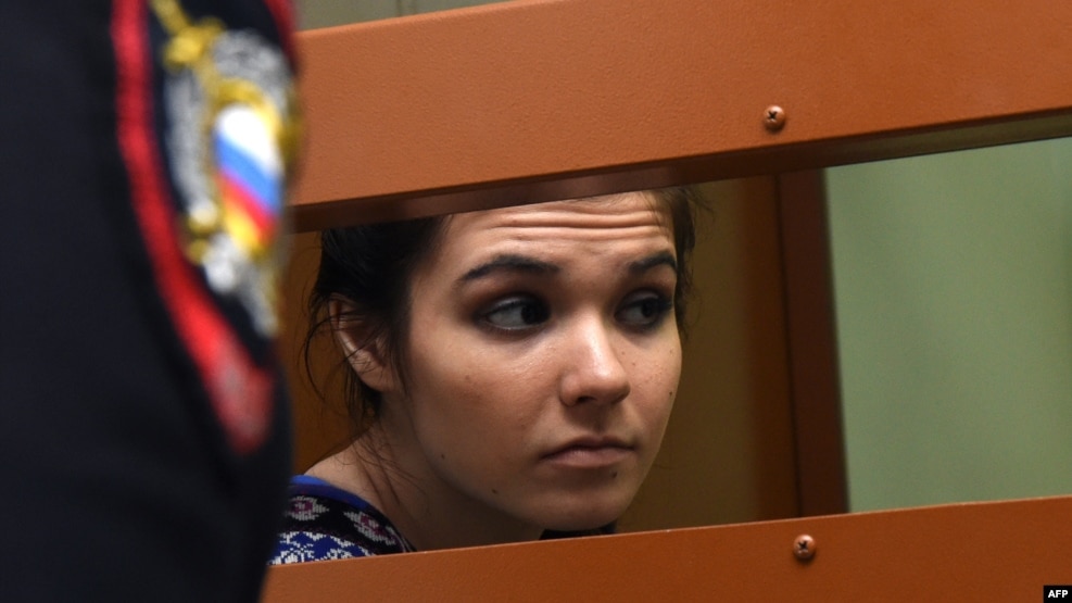 Aleksandra Ivanova (aka Varvara Karaulova) sits inside a defendants' cage during a hearing at a Moscow court last month.