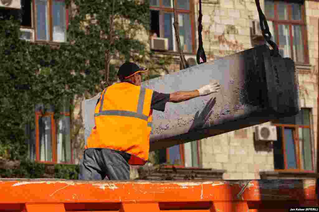 Kyiv city employees dismantle barricades that have stood on Independence Square for months.