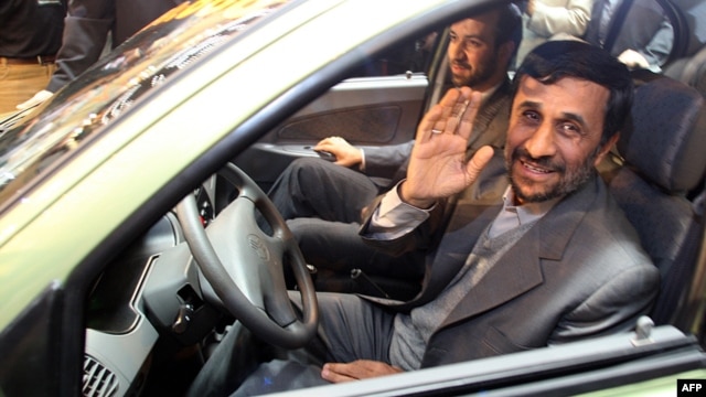 Iranian President Mahmud Ahmadinejad waves to the press as he sits in a car during an inaugural ceremony for Saipa group's All-Iranian Automobile production line, Miniator, in Tehran in December 2008.